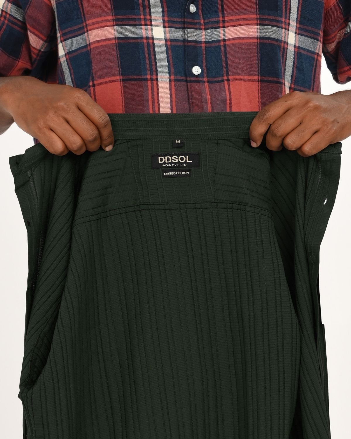 Close-up_of_clothing_tag_inside_dark_green_textured_short-sleeve_shirt_showing_DDSOL_branding