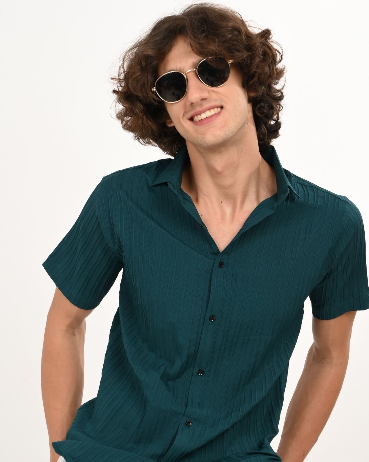 Smiling_model_in_teal_green_textured_short-sleeve_shirt_with_shades